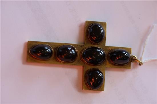 A late 19th century yellow metal and six stone cabochon garnet set cross pendant, 6cm, gross 15.4 grams.